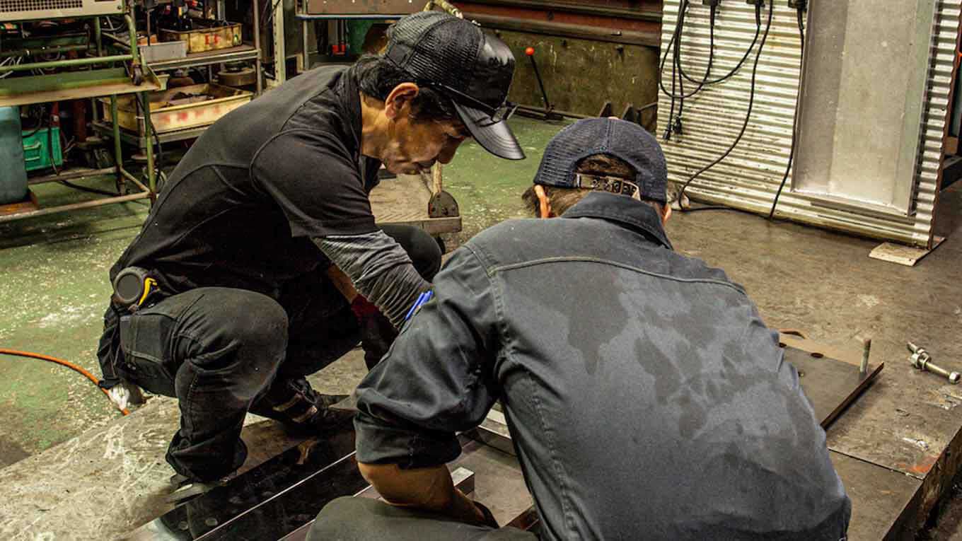two men in a work shop two men in a work shop