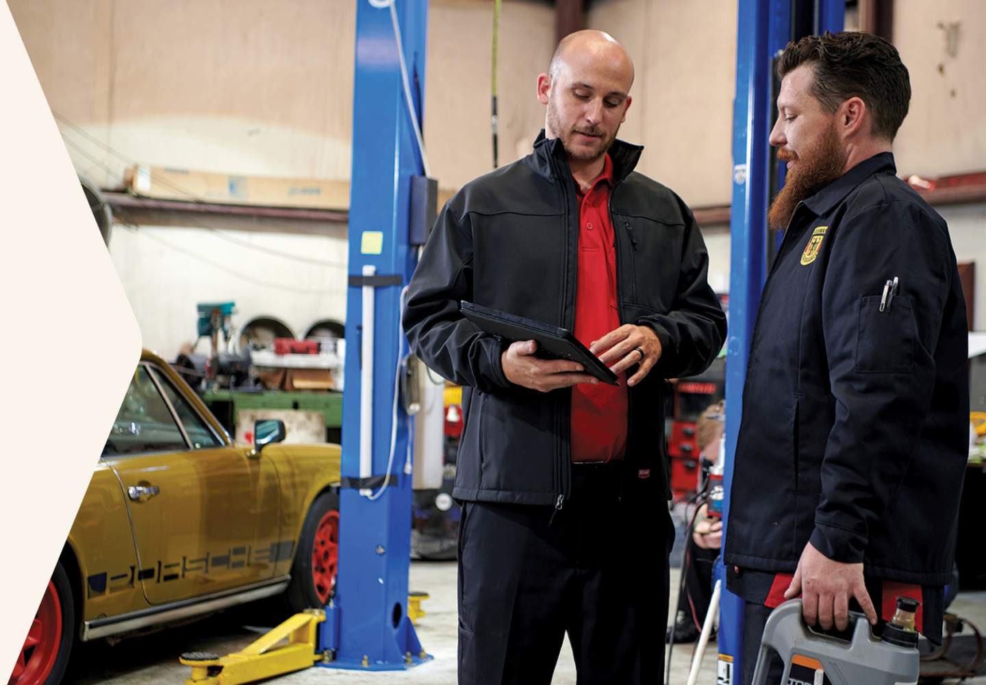 two workers in an autoshop wearing Red Kap workwear two workers in an autoshop wearing Red Kap workwear