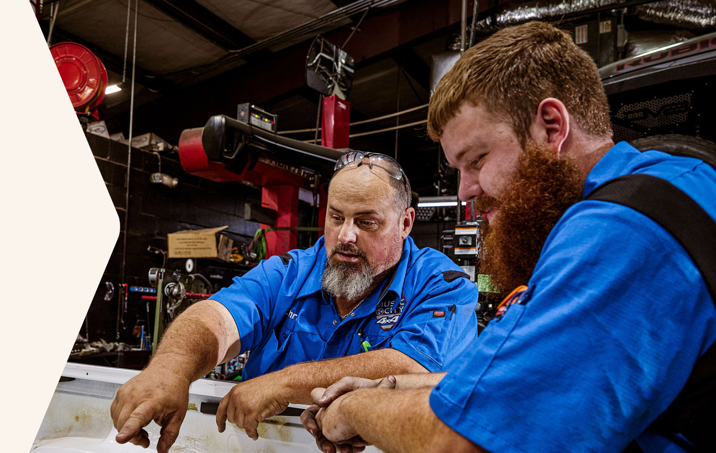 two auto workers wearing customized Red Kap work shirts two auto workers wearing customized Red Kap work shirts